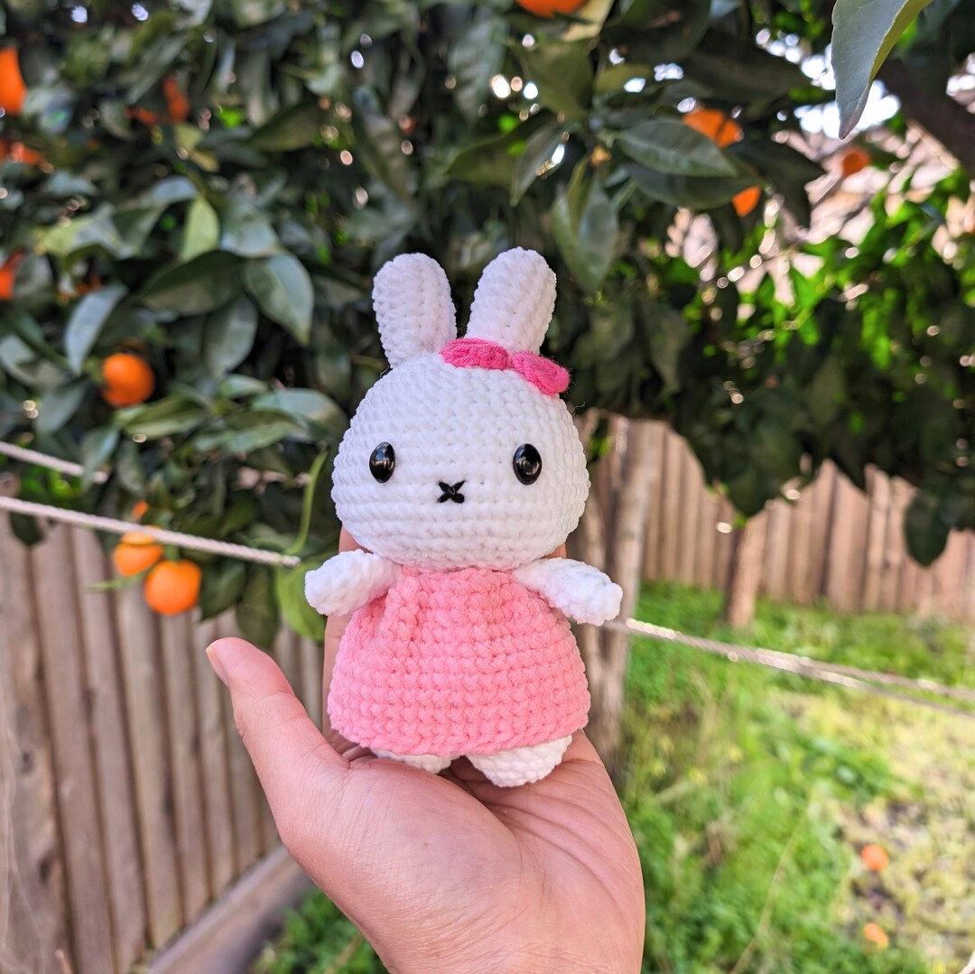pretty bunny amigurumi in pink dress summer bunny this baby bunny is wearing a pink dress and a sun hat. both accessories are removable! this is probably one of my favorite designs, so whimsical and summery ~